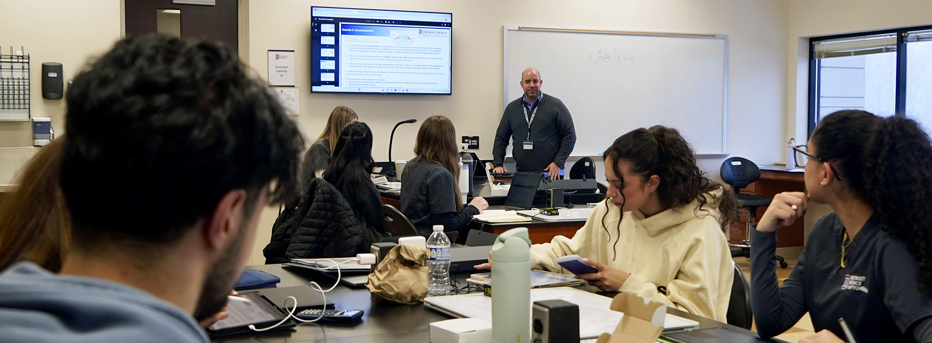 instructor giving lecture to students