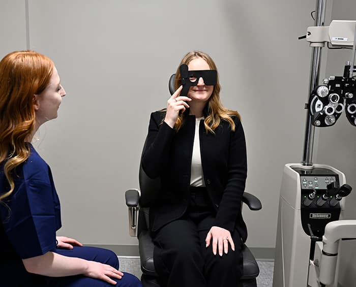 female looking over the selection of glasses at Detroit Mercy Eye Institute