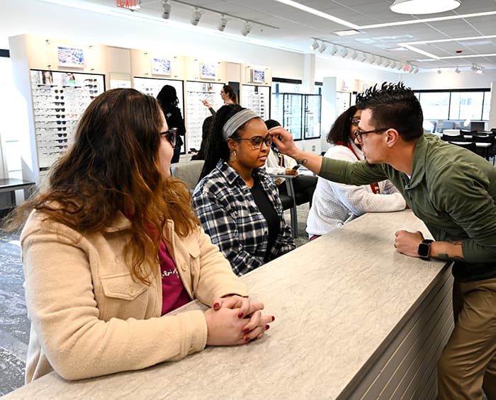 eye institute clinician helping select glasses of patients