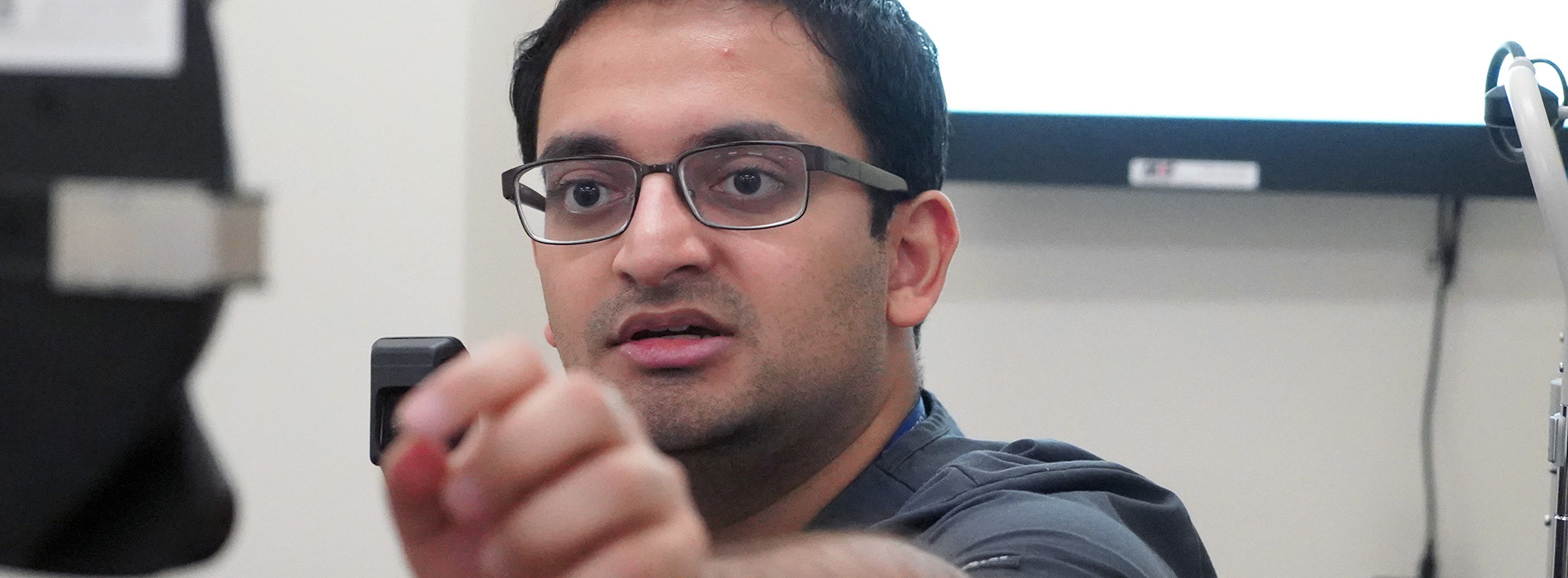 eye exam with arm extended