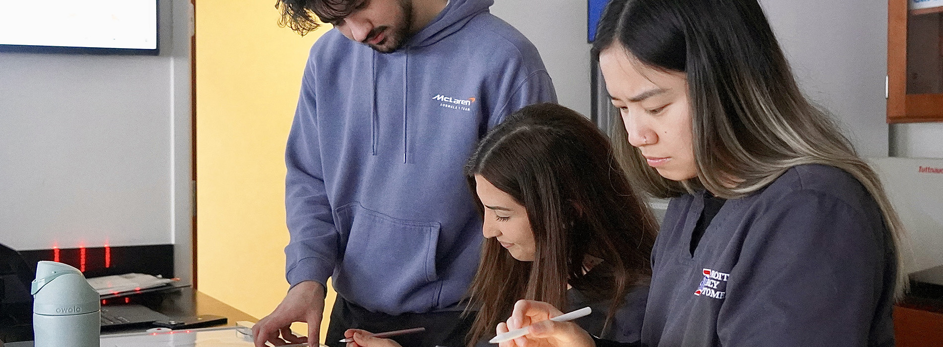 students looking down at ipads